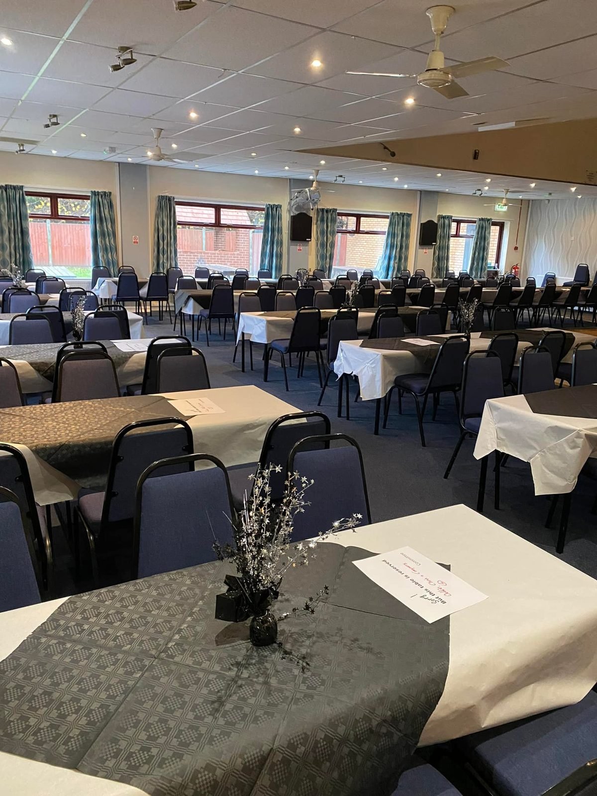 The function hall at Catshill Social Club set up with tables and chairs