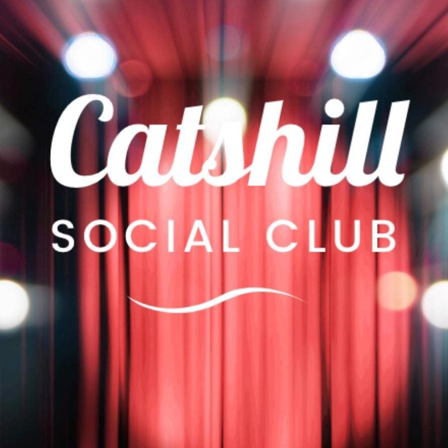 Catshill Social Club crest on a stage curtain
